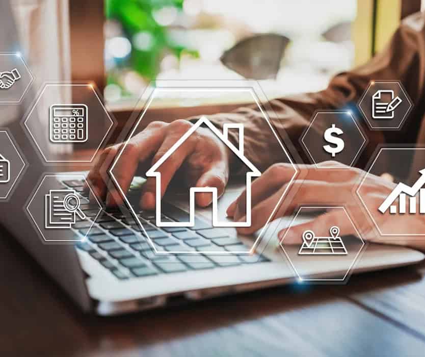 Person typing on a laptop with digital icons related to real estate, key property management, and finance—including a house, dollar sign, calculator, and graphs—overlaid on the image.