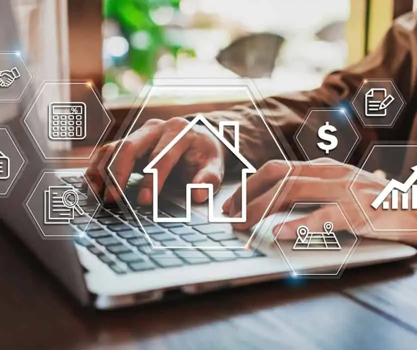 Person typing on a laptop with digital icons related to real estate, key property management, and finance—including a house, dollar sign, calculator, and graphs—overlaid on the image.